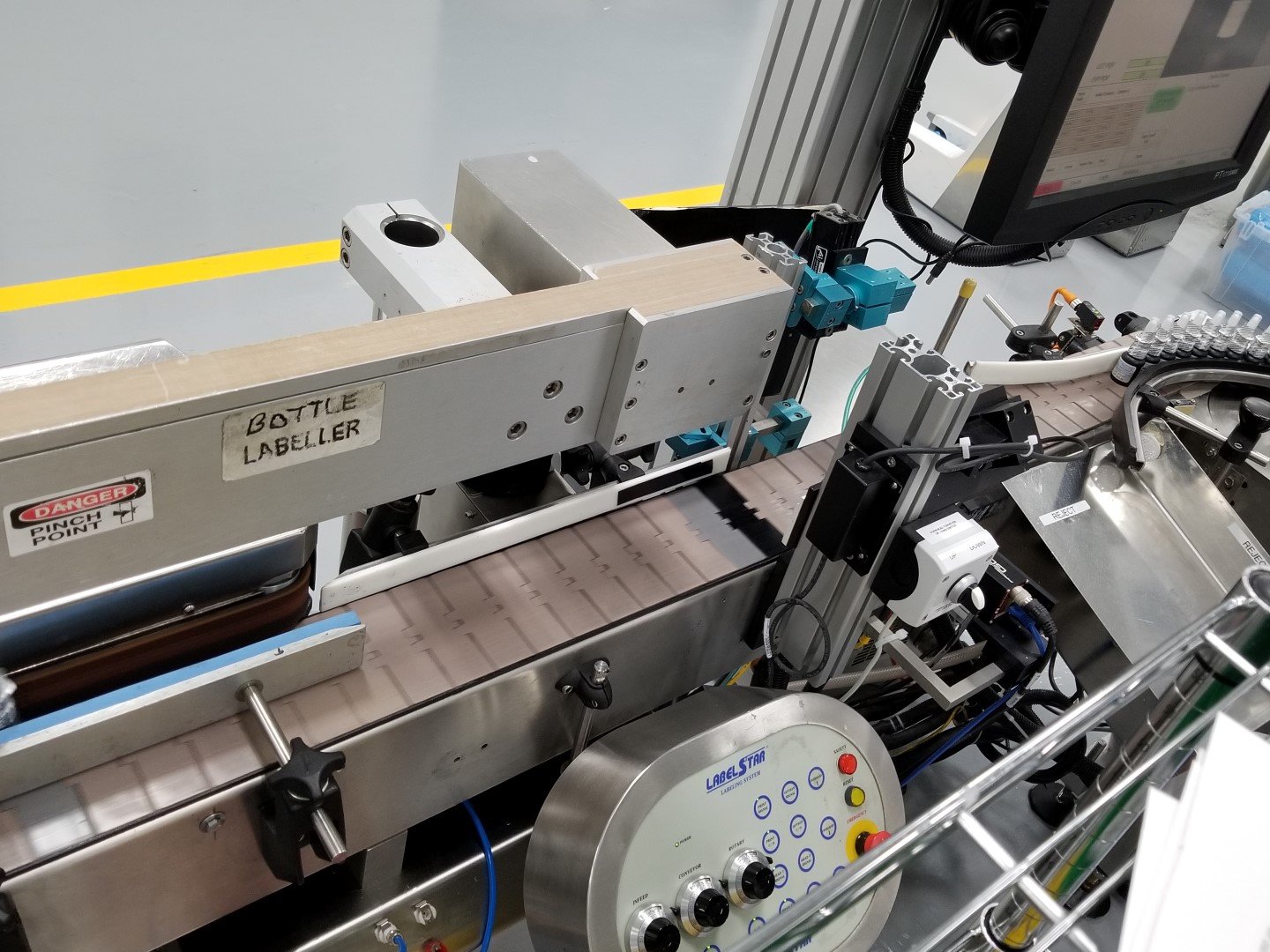 Used Capmatic Labelstar wrap around labeler with hot stamp coder and vision system